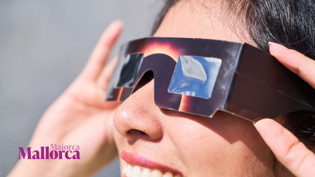 Close-up of a woman wearing protective solar eclipse glasses outdoors
