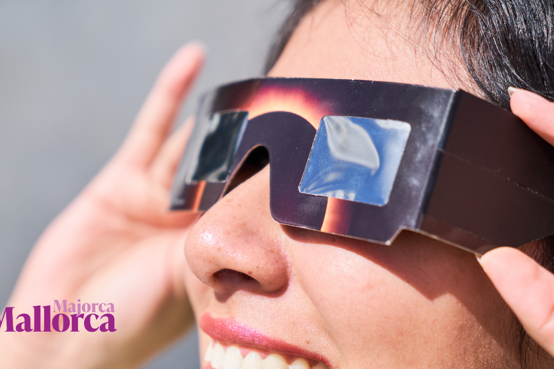Close-up of a woman wearing protective solar eclipse glasses outdoors