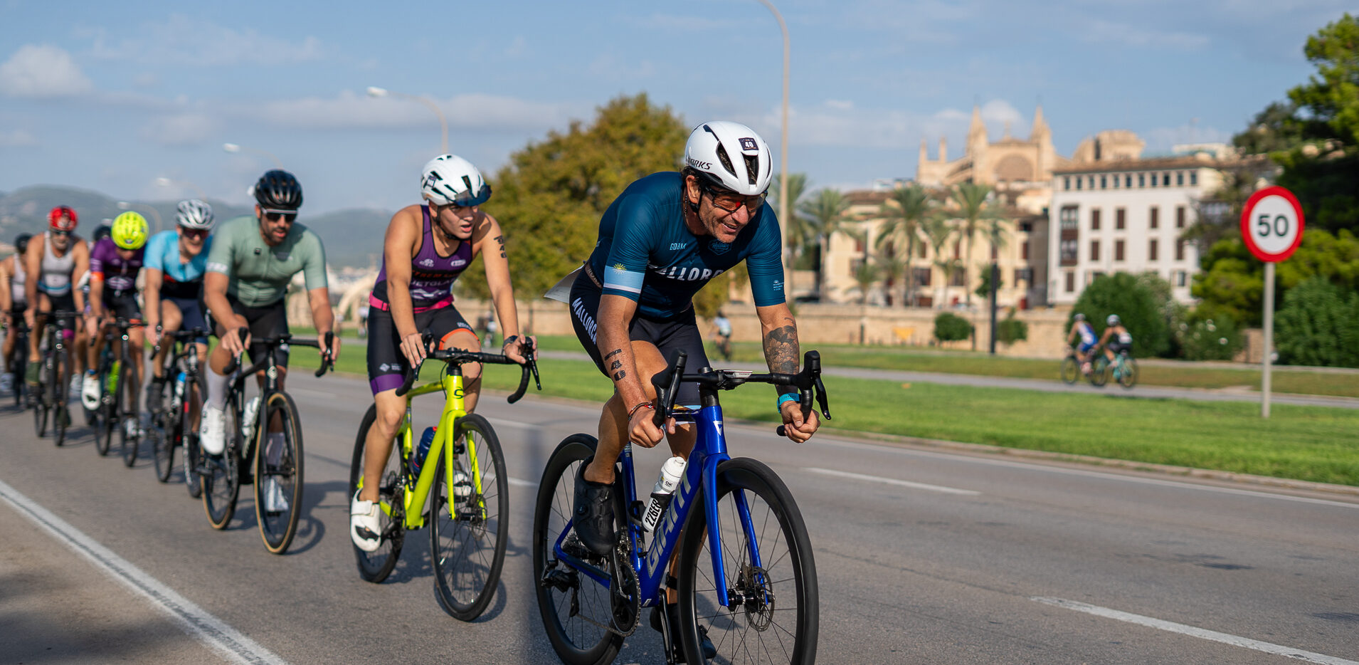Athletes competing in the Port de Palma Triathlon in front of the Palma Cathedral