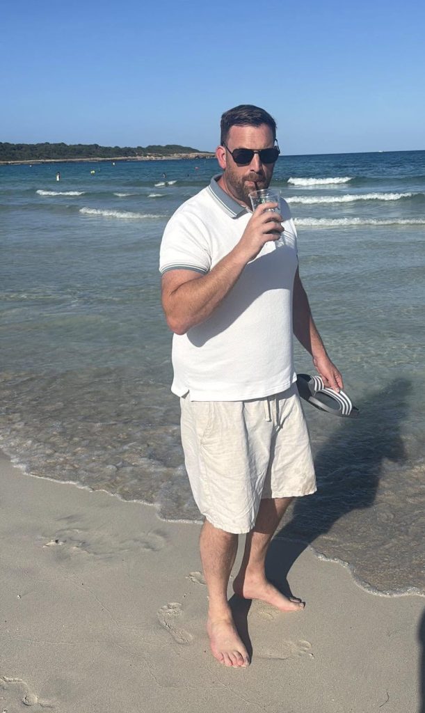 Gregg Thompson, founder of Cleaner Seas Collective, standing on a beach in Mallorca.